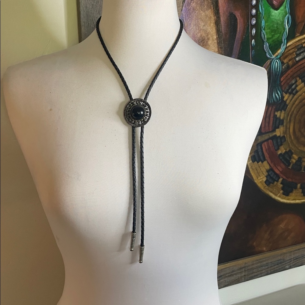 This Southwest Style Bolo Tie Black Braided Rope Silver Tone Slide Black Accent
